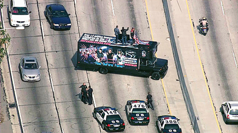 This video image provided by KTLA-TV shows California Highway Patrolmen at the scene of a Los Angeles freeway blocked by a truck advertising a musical group on Oct. 12.