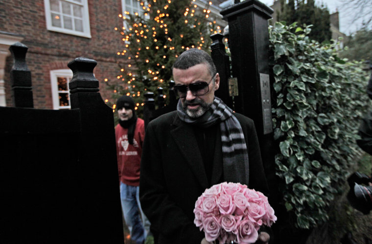 British singer George Michael leaves his house in north London, Friday, Dec. 23, 2011. George Michael, short of breath and appearing weak, said Friday he has recovered from a life-threatening bout with pneumonia that kept him in a Vienna hospital for a month.