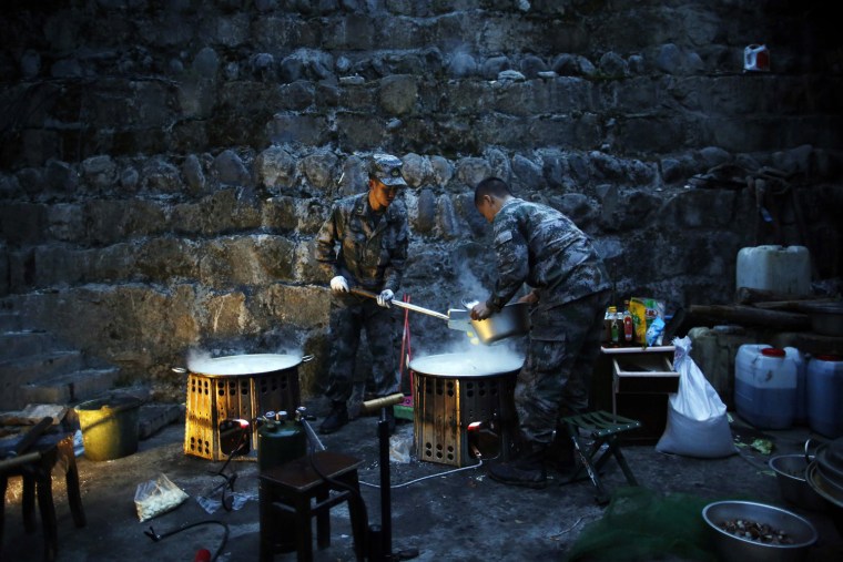 Chinese soldiers cook breakfast in a rescue camp in Taiping town, Lushan County, Sichuan Province, China, on April 23.