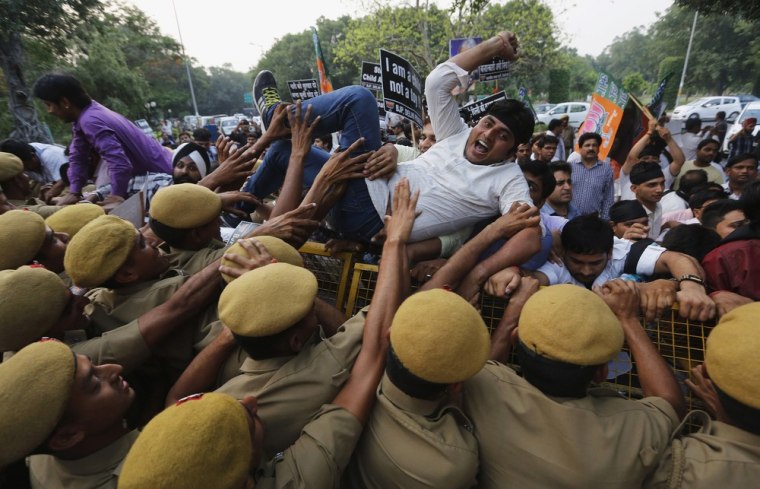 Indian police personnel push a supporter of India's main opposition Bharatiya Janata Party who was trying to cross over the barricade during a protest outside the residence of Delhi's Chief Minister Sheila Dixit in New Delhi on April 23. The police arrested a second man on Monday in connection with the rape and torture of the five-year-old girl in New Delhi. Parliament was adjourned twice amid an uproar about the crime which has rekindled popular fury at widespread sexual violence.