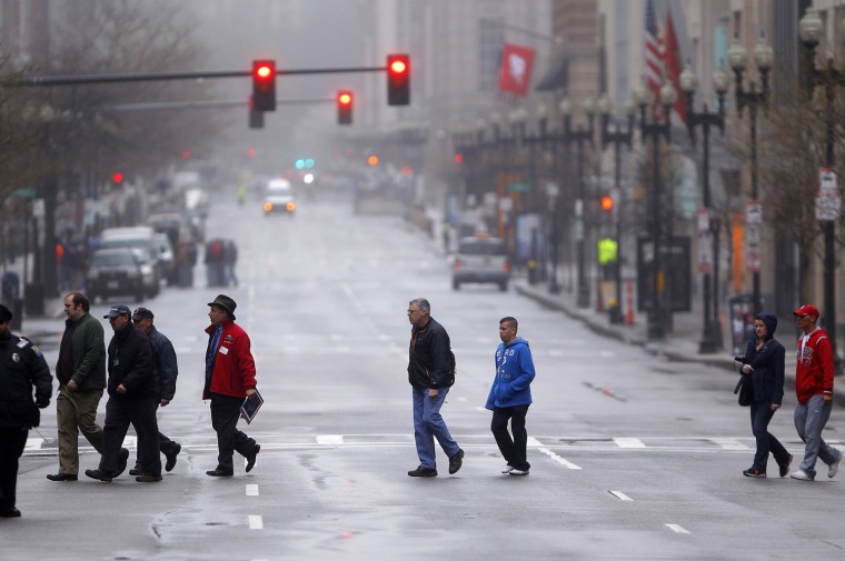 People are escorted across Boylston Street on April 23 as residents and business owners are allowed to return to the street for the first time since the Boston Marathon bombings.