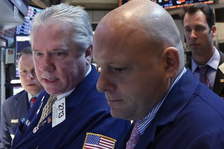 Traders work on the floor at the New York Stock Exchange, April 23, 2013.