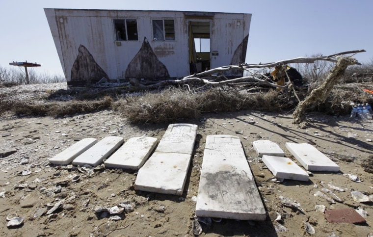 Gravestones are laid out in front of an abandoned structure on the north end of Tangier Island, Va., on April 3. The island and portions of the Virginia coast along Chesapeake Bay are especially vulnerable to climate change; 35 million years ago, a meteor slammed into the lower bay and land mass continues to seep into its crater. Glaciers that gouged out the 200-mile-long bay about 10,000-15,000 years ago are also causing land to sink.