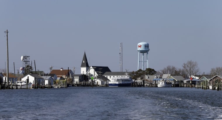 The Swain Memorial Church and a water tower rise above crab shacks on the waterfront of Tangier Island, Va., on April 3. The island's population of 500 is crowded on several ridges of high ground, still only several feet above sea water. Because of its isolation, many residents still retain the linguistic echoes of the island's settlers, primarily from Cornwall along England's southwest coast. A handful of names - Pruitt, Dise, Marshall - dominate the population. John Smith, the intrepid and boastful Jamestown settler, is believed to be the first European to step foot on the island four centuries ago. The arrowheads collected on the beach are remnants of Indians who summered here.