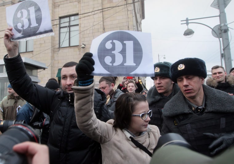 Russian policemen make their way through a crowd to detain opposition activists in Moscow, in this March file photo