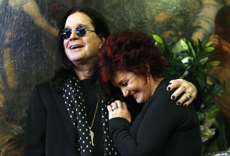 Ozzy and Sharon Osbourne pose in front of some of their belongings to be auctioned in Beverly Hills, California in this file photo taken November 26, 2007. Black Sabbath singer Osbourne apologised on Tuesday for bingeing on drink and drugs over the last year and a half but said he was not getting a divorce from his wife Sharon.  REUTERS/Mario Anzuoni/Files  (UNITED STATES - Tags: ENTERTAINMENT)