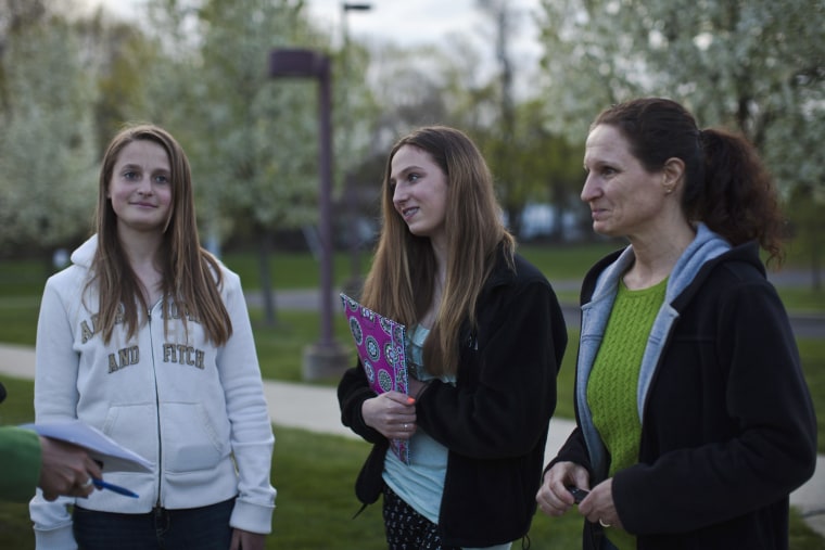 Students Sarah Lachenmayr (L), Samantha Rieche (C) and her mother Anne Rieche arrive to attend a school board meeting in Readington Township, New Jersey, April 23, 2013.