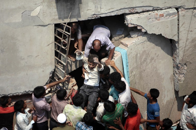 A man who was trapped in an collapsed eight-story building housing several garment factories is reccued in Savar, Bangladesh, April 24.