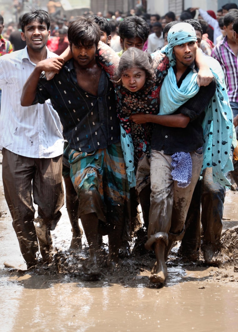 Civilians rescue an injured garment worker during a rescue operation after the eight-story Rana Plaza building collapsed at Savar, Bangladesh, April 24.
