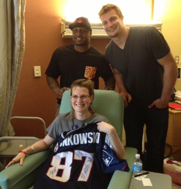 New England Patriots' running back Stevan Ridley and tight end Rob Gronkowski visited Brittany Loring, center, on Monday in her hospital room and signed a jersey for her.