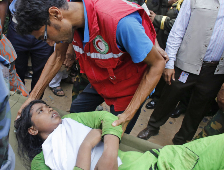 A rescue worker comforts a survivor who was trapped inside the rubble of the collapsed building in Savar, Bangladesh, on April 25.