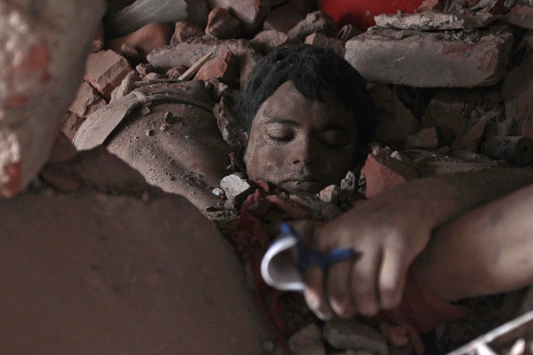 A victim's body lies amid rubble at the site of a building collapse in Savar, Bangladesh, on April 25.