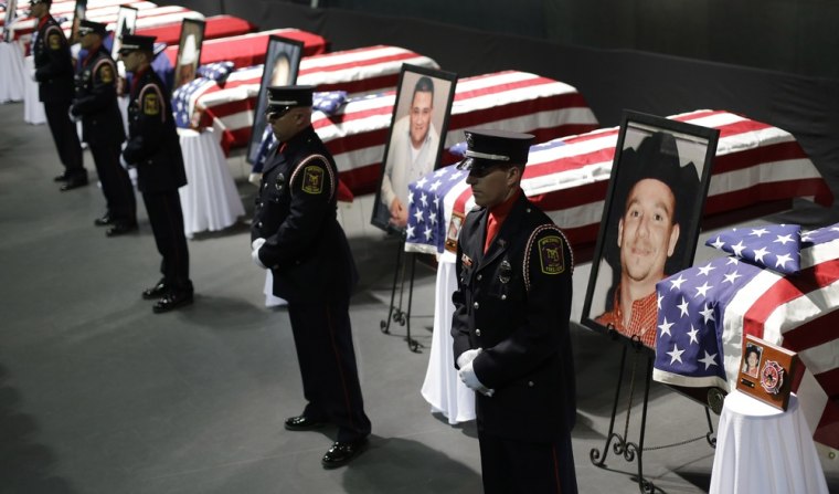 Honor guards stand in front of caskets prior to a memorial service for first responders who died in last week's fertilizer plant explosion in West, Texas, on Thursday, in Waco, Texas.