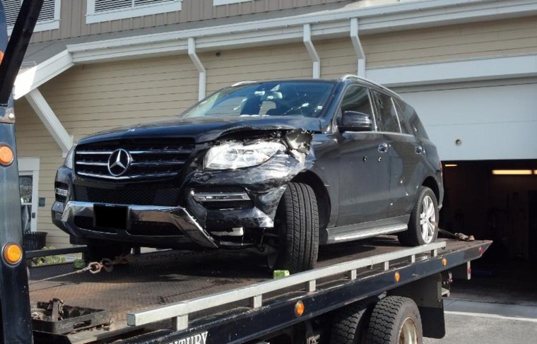 In this photo obtained by NBC News, a tow truck delivers a bullet-riddled black Mercedes SUV to police headquarters in Watertown, MA, on Friday afternoon, April 19th.
