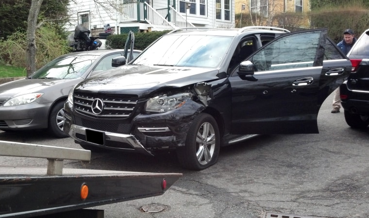 In this photo obtained by NBC News, the Mercedes SUV awaits pickup by a tow truck last Friday morning, April 19th, at the corner of Spruce and Lincoln Street in Watertown.