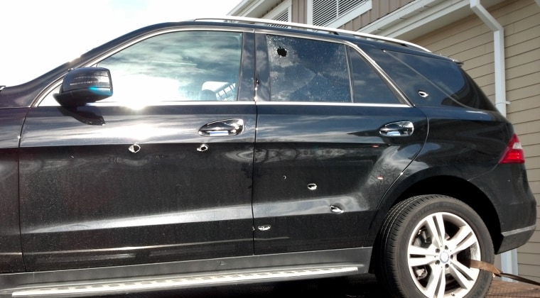Bullet holes in the driver's side door and rear passenger door of the Mercedes. Photo obtained by NBC News.
