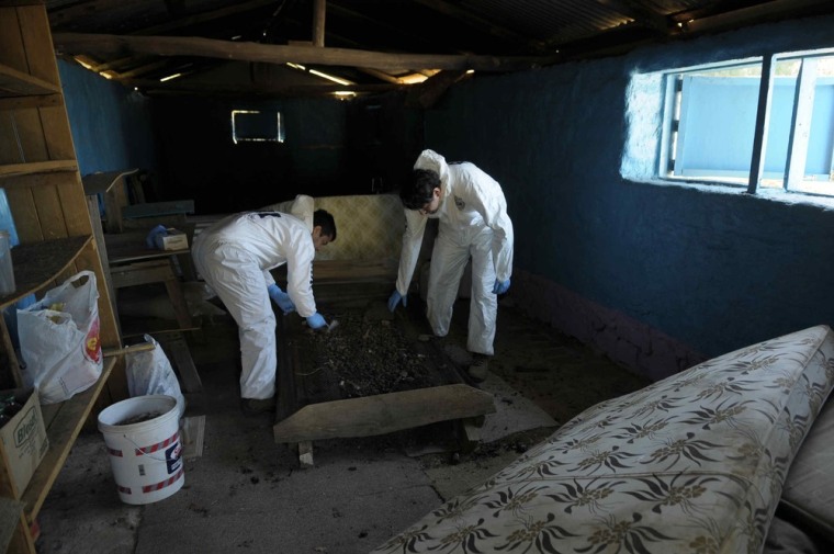 Investigators search for evidence in a house that was used to perform rites by a sect in Colliguay, Chile.