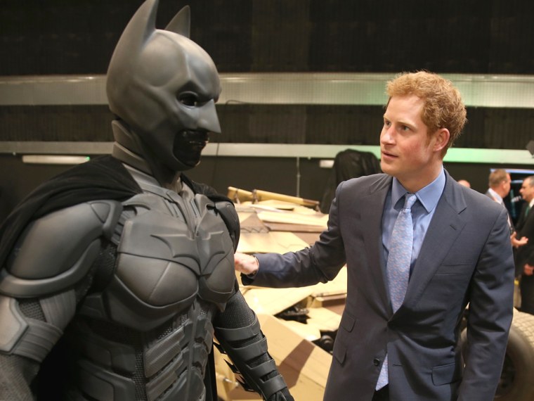 LONDON, ENGLAND - APRIL 26: Prince Harry looks at a 'Batsuit' which was use in the Batman films during the Inauguration Of Warner Bros. Studios Leaves...