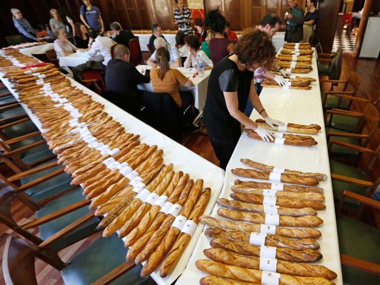 Jury members taste and select baguettes, French bread, which compete for the 'Grand Prix de la Baguette de la Ville de Paris' (Best Baguette of Paris ...