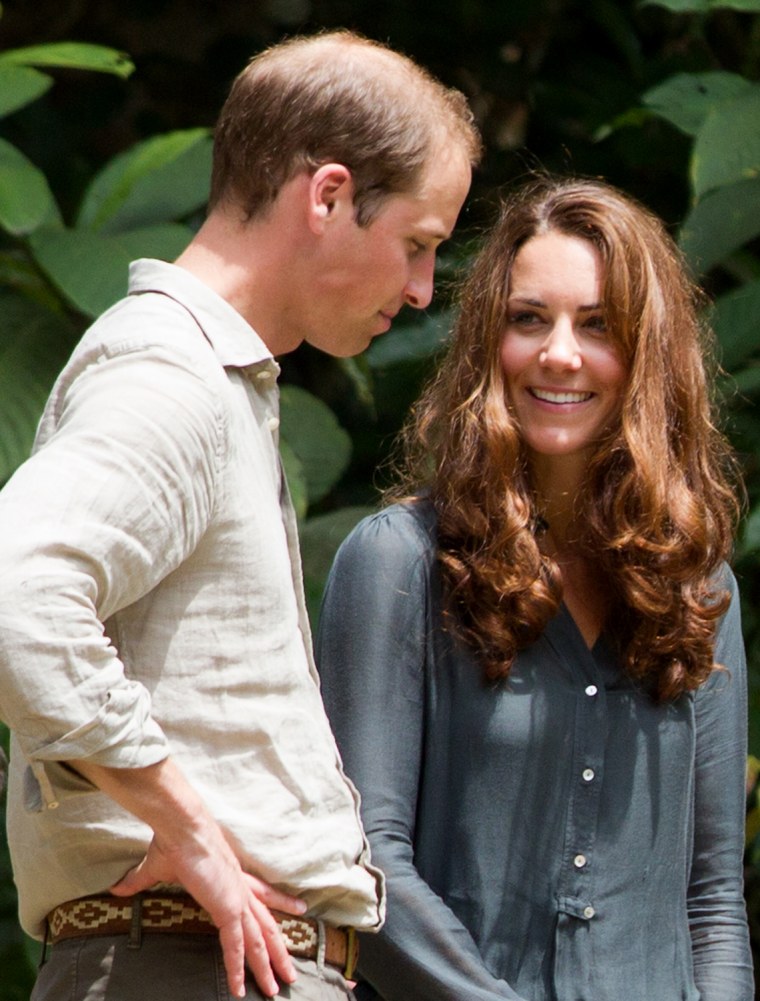Britain's Prince William (L) and Catherine, the Duchess of Cambridge (R), speak to each other during their visit at the Borneo Rainforest Lodge in Dan...