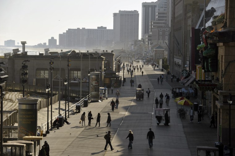 People walk on the Atlantic City boardwalk looking south from Caesars Atlantic City Thursday, April 25, 2013. Hurricane Sandy did mimimal damage to At...