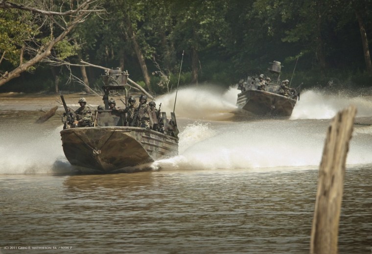 Special Warfare Combatant-craft Crewman (SWCC) move though rivers at a high rate of speed in specially designed Riverine boats which are outfitted with heavy weapons and mini-guns capable of firing 2,000-6,000 rounds a minute.