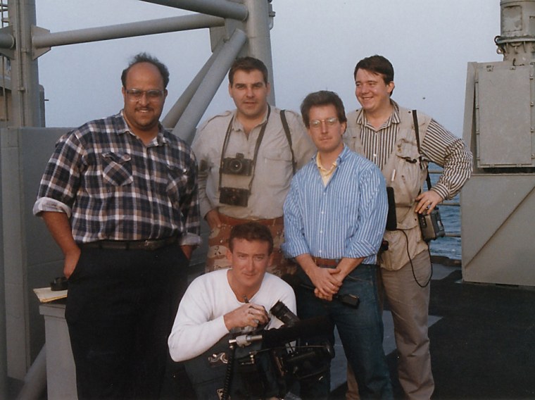 Department of Defense Combat Correspondents during Desert Storm aboard the USS Curtz with SEAL Team 5 and helicopters of the 160th Night Stalkers. Greg Mathieson is seen with the tan shirt and a camera around his neck. NBC News Correspondent Kerry Sanders is seen in the blue striped shirt.