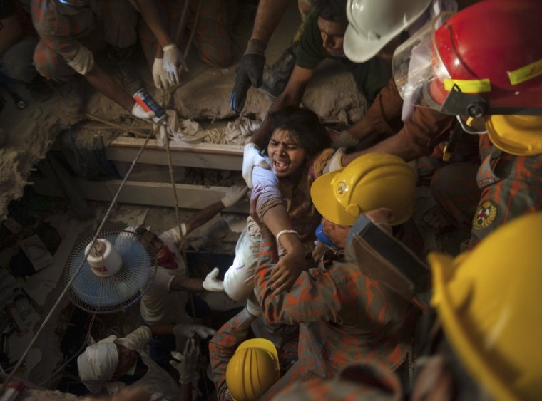 Rescue workers pull a garment worker from the rubble of the collapsed Rana Plaza building, in Savar, 19 miles outside Dhaka, on April 27, 2013.