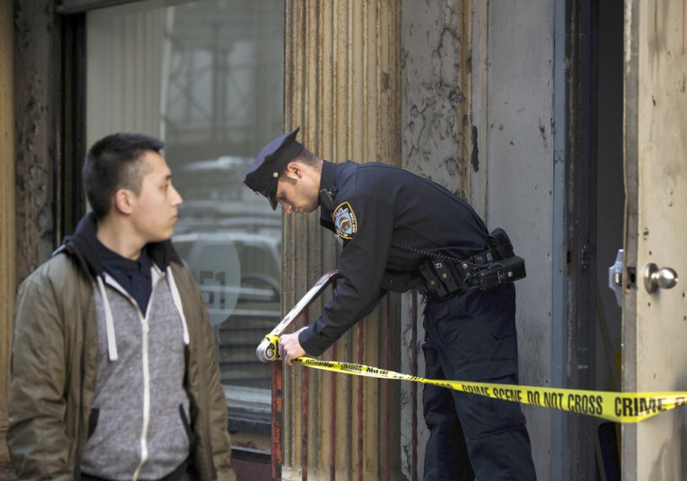 A New York Police Department officer on Friday guards a door in front of 51 Park Place where debris from one of the 9/11 airplanes is believed to have been found in New York.