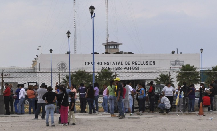 Relatives of inmates wait for information on their loved ones after a prison riot at La Pila prison in the Mexican state of San Luis Potosi.