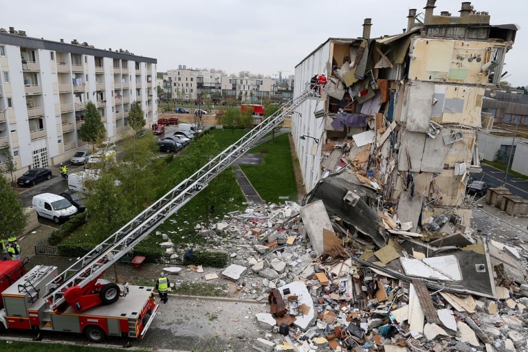 Firemen are at work near the collapsed section of an apartment building on April 28, 2013 in Reims, France.