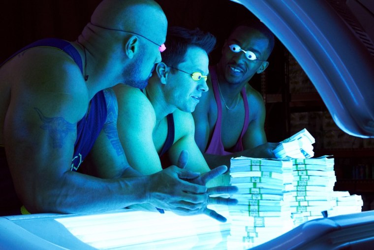 Dwayne Johnson as Paul Doyle, left, Mark Wahlberg as Daniel Lugo, center, and Anthony Mackie as Adrian Doorbal in the film,