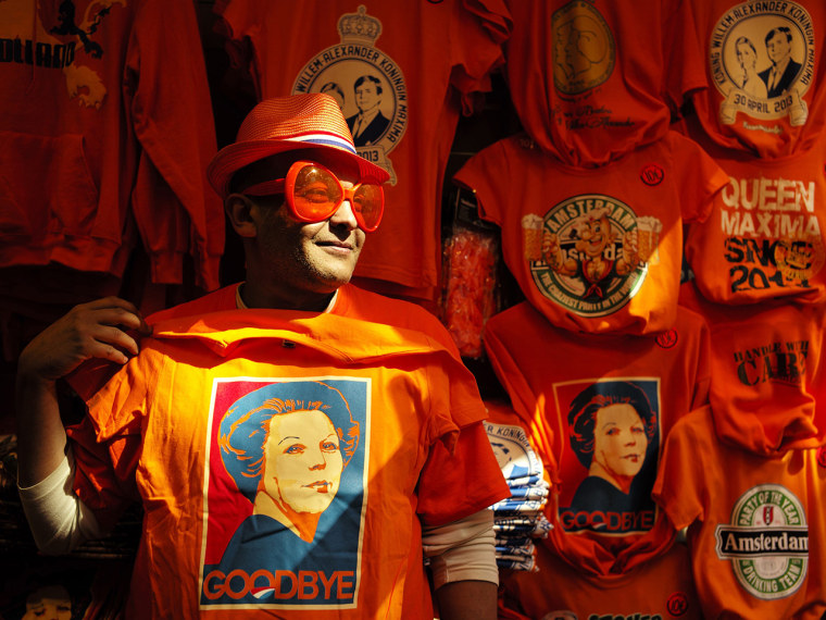 A man wearing shades displays a t-shirt depicting Dutch Queen Beatrix in a souvenirs shop in Amsterdam April 29, 2013. The Netherlands is preparing fo...