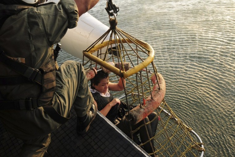 A passenger of a hot air balloon that crashed in the sea off Peru is rescued by a Peruvian Navy helicopter on Sunday.
