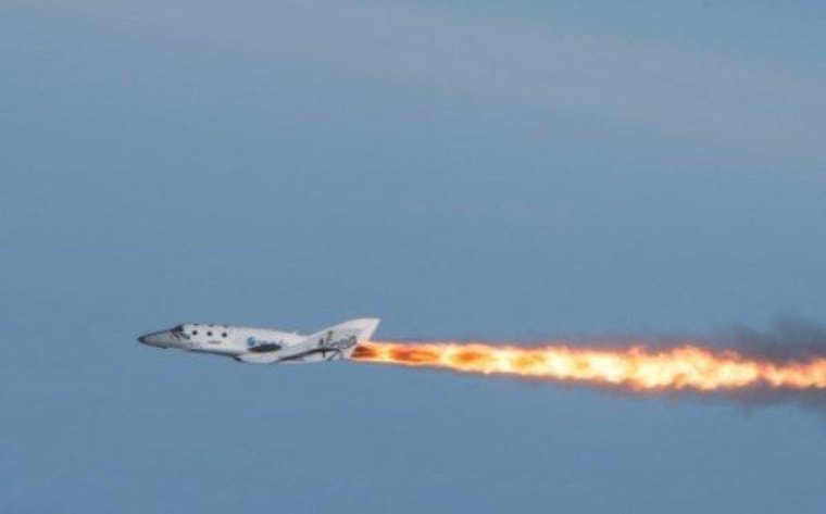 SpaceShipTwo fires up its rocket engine for the first time in flight on Monday.