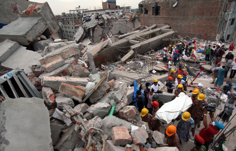 A body is carried out from the collapsed garment factory building April 28 in Savar, near Dhaka, Bangladesh.