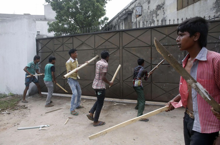 Garment workers try to break the gate of a factory April 29 during a protest to demand capital punishment for those responsible for the collapse of the Rana Plaza building in Savar, outside Dhaka, Bangladesh.