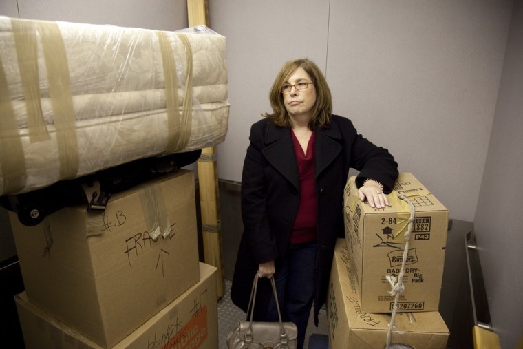 Ann Valencia looks on as movers unload a truck full of her belongings and load them into a storage unit she rented. Valencia has had to downsize and move in with a friend after she could no longer afford her two-bedroom apartment in Bayside, New York.