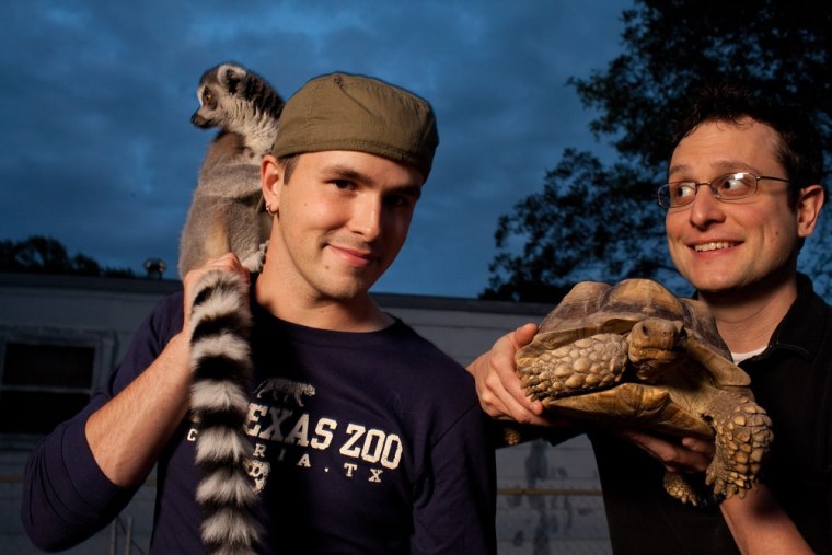 Nathan Palmer, left, and ring-tailed lemur, Grover, with partner Brett Jones, holding African spur thigh tortoise, Shelly, at their home in Victoria, Texas.