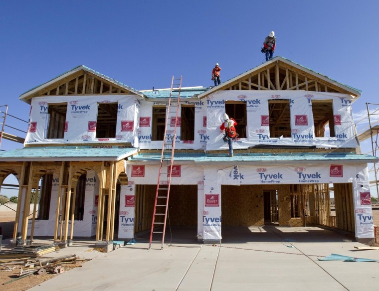 Builders frame a new home in Queen Creek, Ariz., this summer.