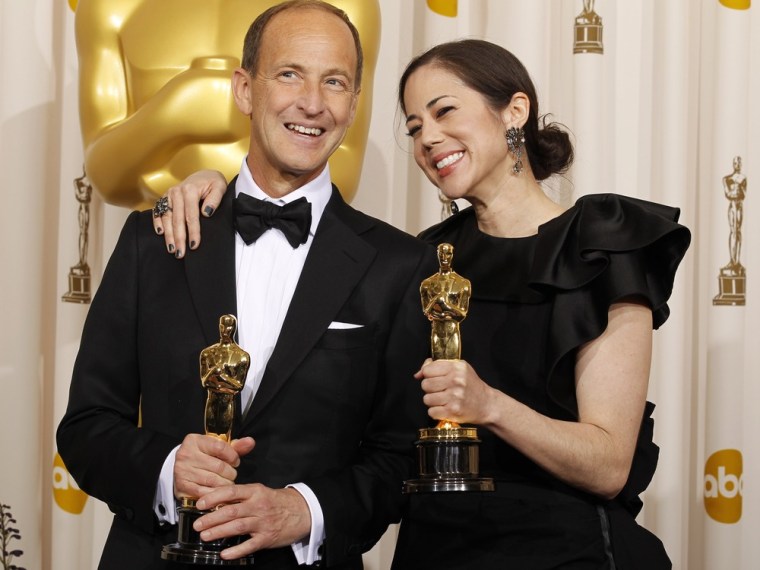 Charles Ferguson (L) and Audrey Marrs (R) pose backstage with their Oscars  for for Best Documentary Feature for the 'Inside Job'
