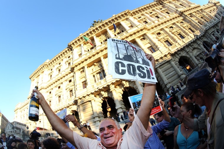 People react in front of the Justice palace to the verdict of the 'Corte di Cassazione' (Supreme Court) during the final session to judge former Italian Prime Minister Silvio Berlusconi on Aug. 1, in Rome, Italy.