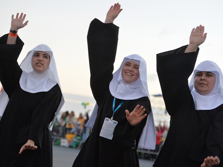 Nuns dance as they wait for the start of a vigil on Copacabana beach in Rio de Janeiro.