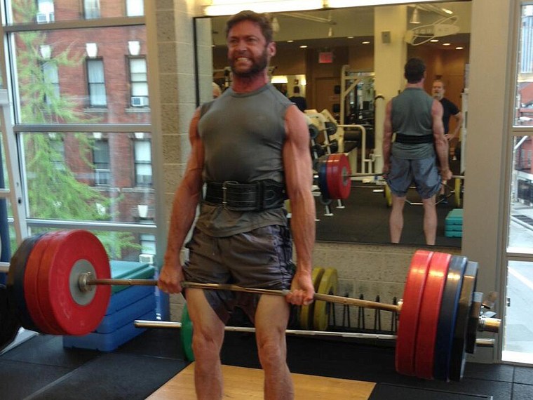 A ripped Hugh Jackman lifts (many) weights.