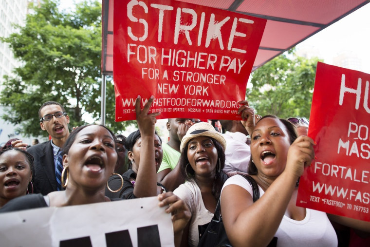 Demonstrators in support of fast food workers protest outside a McDonald's as they demand higher wages and the right to form a union without retaliati...