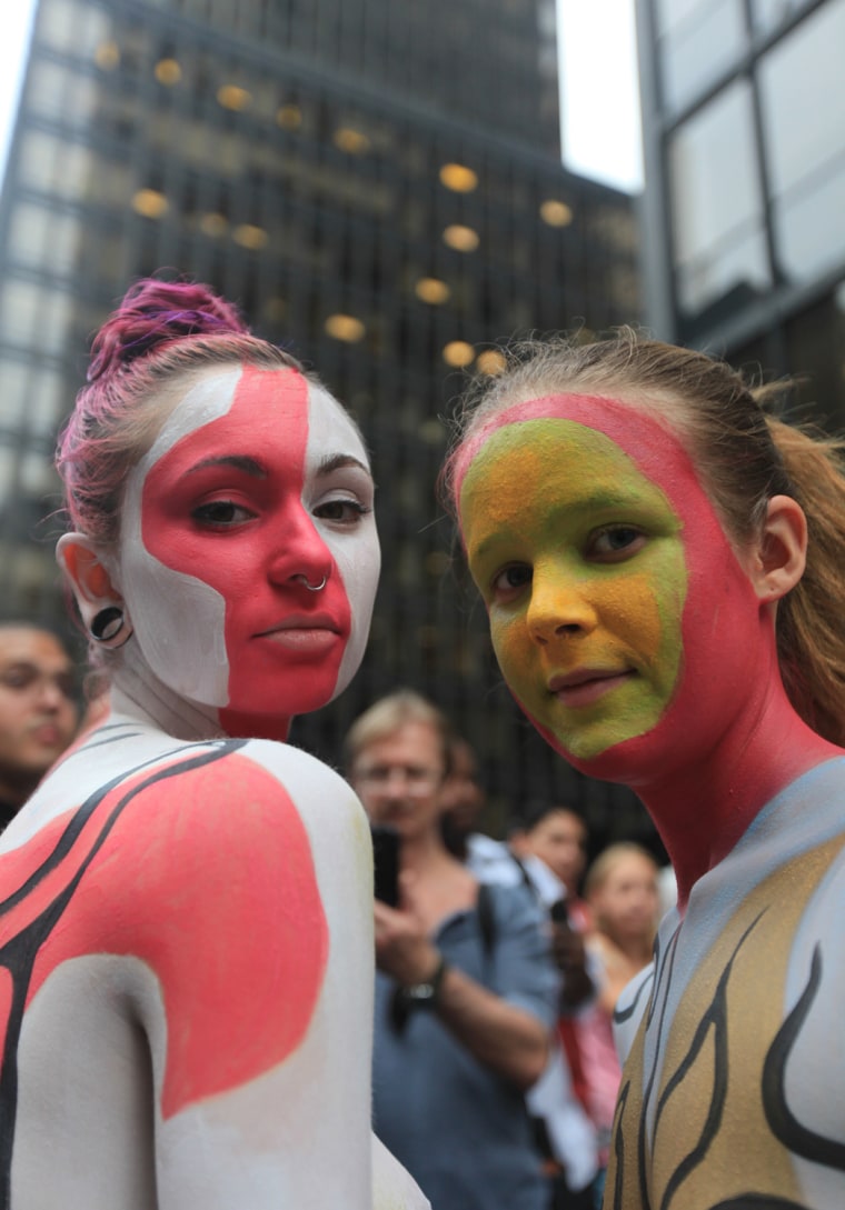 Nudists Dylan Hall, left, and Felicity Jones participate in public body painting event by artist Andy Golub near New York's Times Square on July 31, 2013.