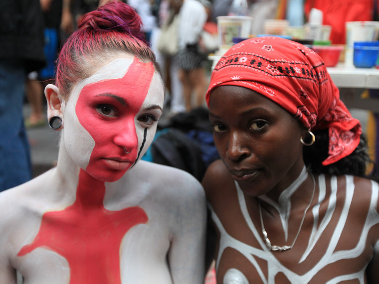 Nudists Dylan Hall, left, and Myscha participate in public body painting event by artist Andy Golub near New York's Times Square on July 31, 2013.