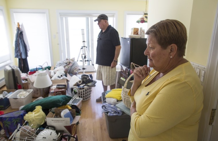 Christine and George Donley, both 63, are finally moving home after nine months of being displaced by Hurricane Sandy. All of their possesions that they could save are now piled up in one room on the second floor as workers finish repairing their home.