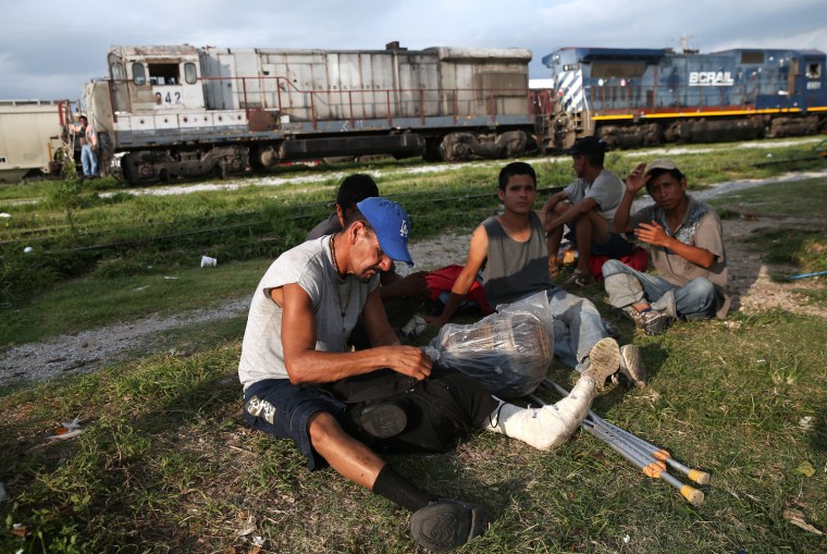 Central American immigrants prepare to board on a freight train in Arriaga, Mexico.