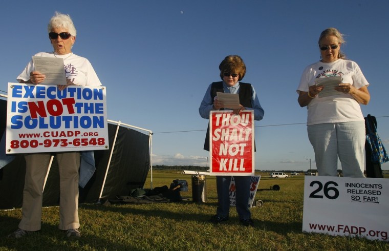 Death penalty opponents join in a chant across from Florida State Prison in Raiford, Fla. Tuesday, Oct. 23, 2012. The 11th U.S. Circuit Court of Appeals on Tuesday night blocked the scheduled execution of 64-year-old John Errol Ferguson, who was convicted 34 years ago of eight slayings that jolted South Florida in the 1970s. Florida officials immediately asked the U.S. Supreme Court to lift the stay. (AP Photo/Phil Sears)